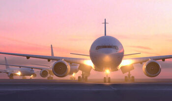 Canvas Print Airplanes taxiing on runway at sunset