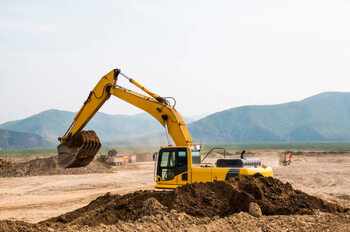Canvas Print Excavator loading earth into dump