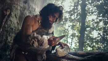 Canvas Print Primeval Caveman Wearing Animal Skin Holds