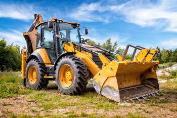 Canvas Print Yellow earth mover in construction site