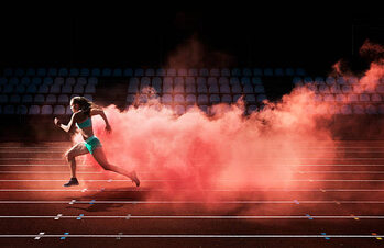 Juliste athlete running in red smoke