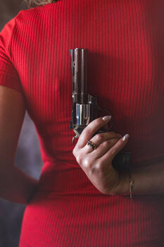 Plakat young woman in red dress holding gun pistol
