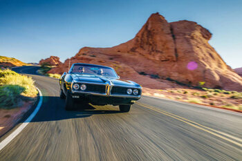 Poster couple driving together in cool vintage