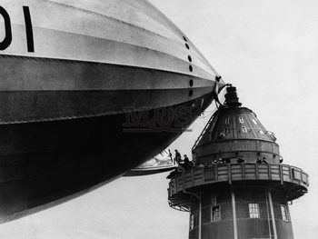 Dirigibile leaning against tower Art Print