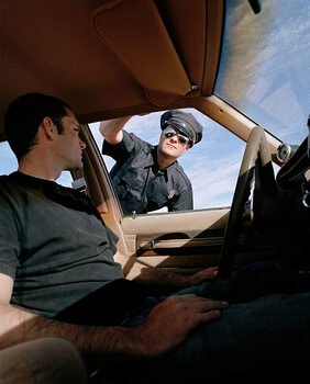 Poster Man in car looking at police officer, close-up