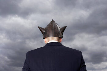 Poster Man wearing metal 'Viking' helment, rear view
