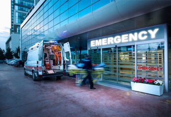 Poster Paramedics taking patient on stretcher from