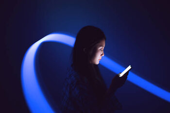 Poster Young Asian woman using smartphone on