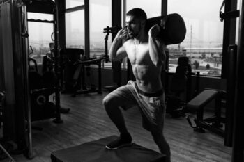 Poster Young Fit Man Doing Box Jumps In Gym