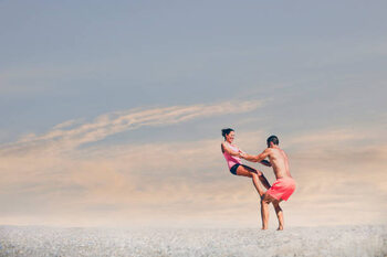 Poster Young sporty couple practicing acroyoga exercises