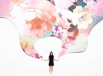 Camisola woman holding flowered wallpaper