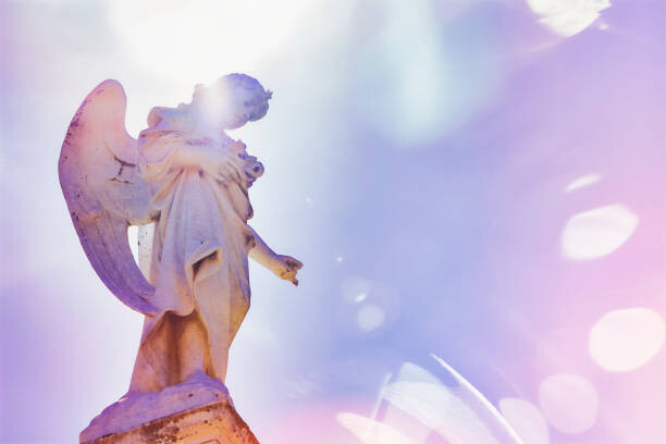 Sticker Angel looking down on a graves at a cemetery