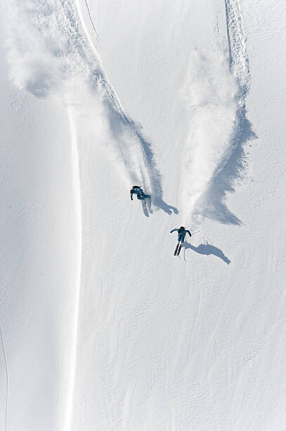Valokuvataide Aerial view of two skiers skiing