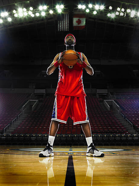 Valokuvataide Basketball player holding basketball, low angle