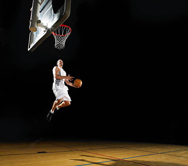 Valokuvataide Basketball player slam dunking ball