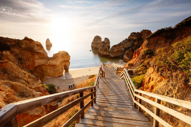 Arte Fotográfica Boardwalk to Camilo beach at sunrise,  Portugal
