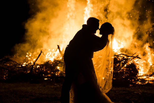 Art Photography Bride and Groom silhouette with Fire behind them