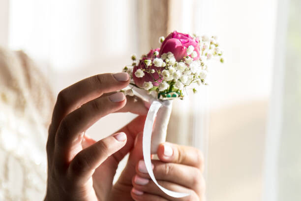 Art Photography Bride holding a buttonhole. Gentle hand