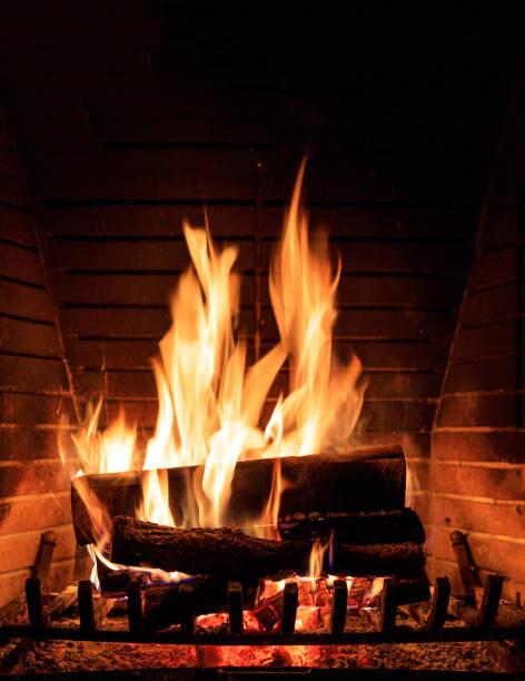 Arte Fotográfica Fireplace burning wood logs, cozy warm home christmas time