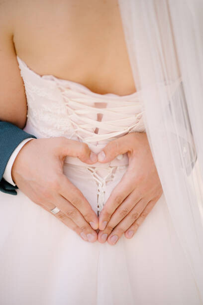 Art Photography Groom holds his hands in the