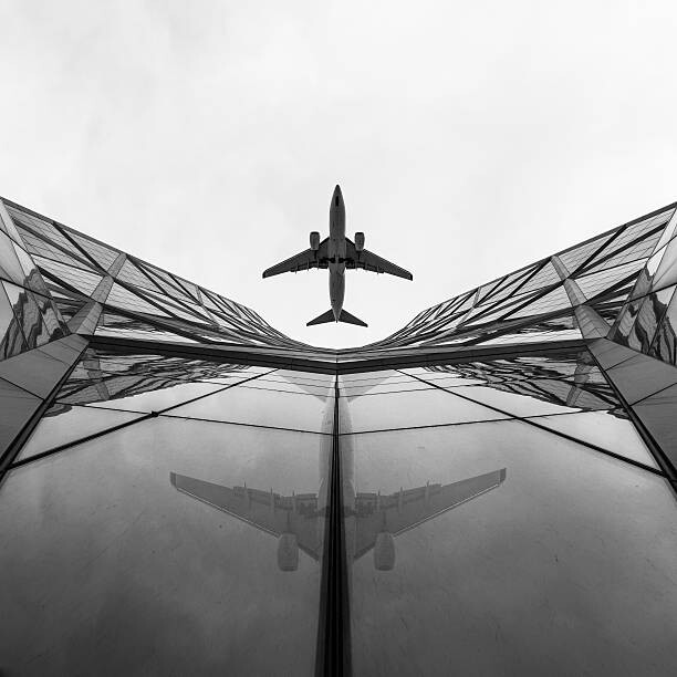 Art Photography Jet airplane passes overhead skyscrapers