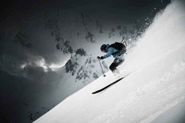 Art Photography Male skier speeding down steep mountainside,