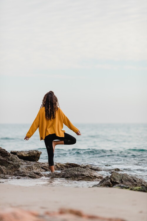 Art Photography practicing yoga at beach