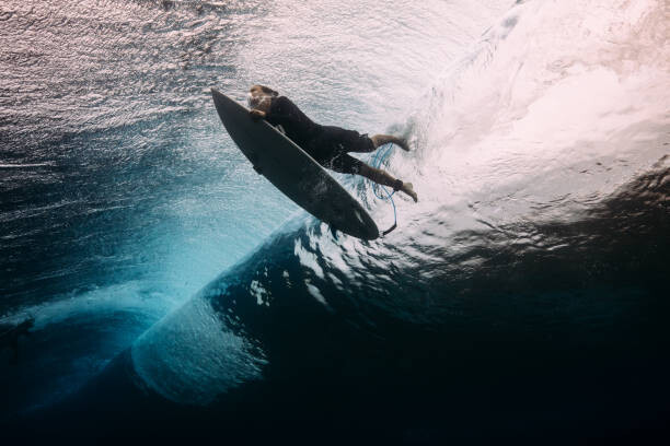 Art Photography Surfer dives beneath a wave