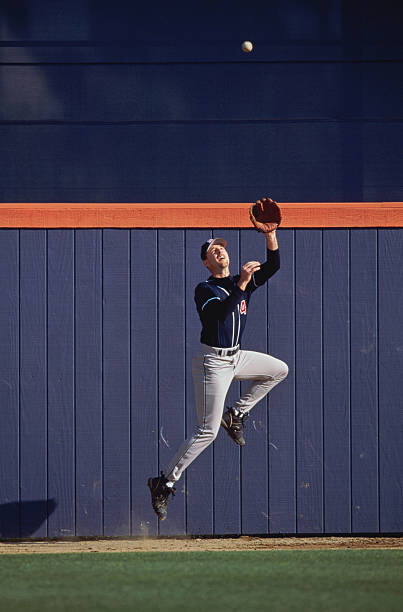 Sticker Baseball outfielder leaping to catch ball