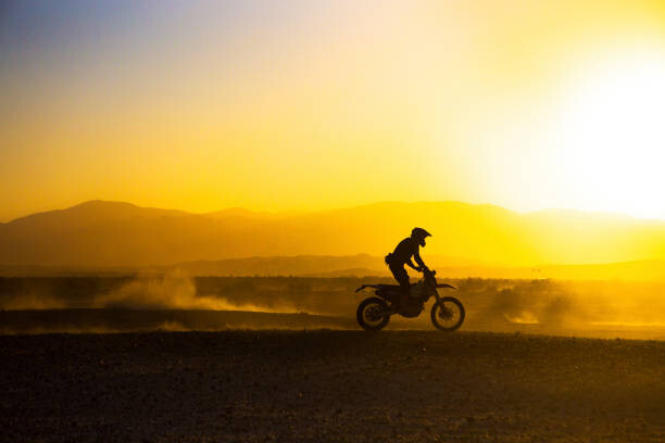 Canvas Print A motorcycle races through the desert.