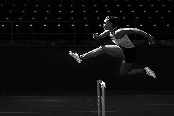 Canvas Print A runner taking on the hurdles.