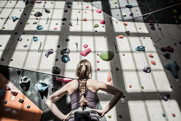 Canvas Print Athlete examining rock wall in gym