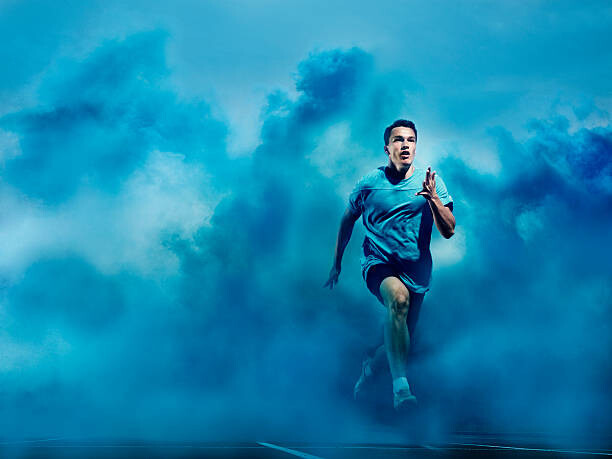 Canvas Print athlete running in blue smoke