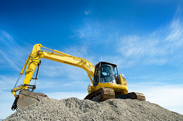 Canvas Print Backhoe on a Gravel Pile