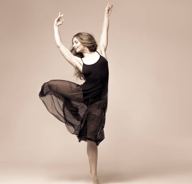 Canvas Print Ballet dancer woman black dress. Studio shot.
