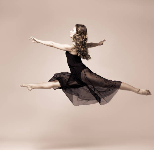 Canvas Print Ballet dancer woman black dress. Studio shot.
