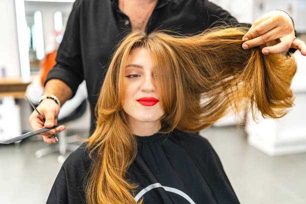 Canvas Print Beautiful young woman getting her hair cut