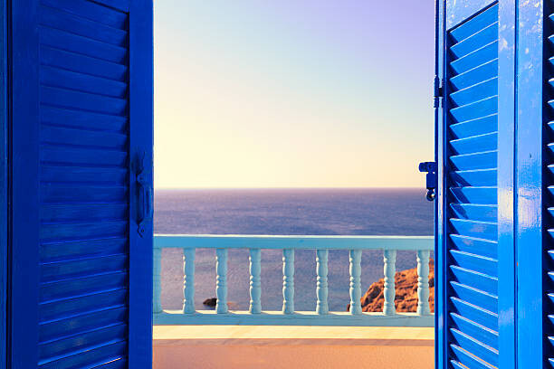 Canvas Print Blue Shutters Open onto Sea and Sky at Dawn