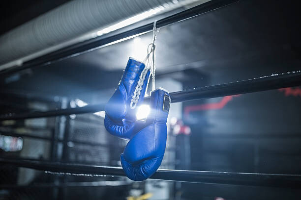 Canvas Print Boxing gloves hanging in boxing ring
