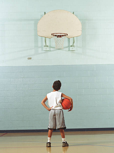 Canvas Print Boy  holding basketball, looking at
