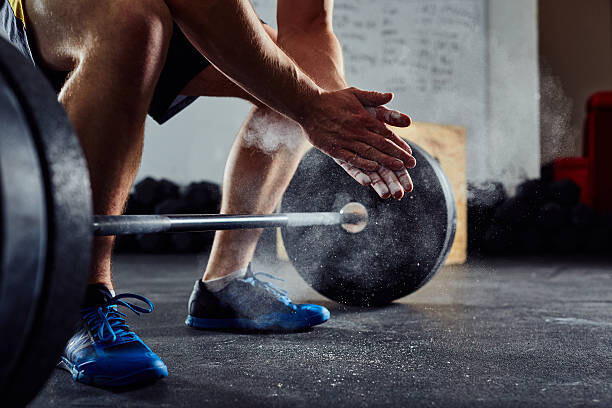 Canvas Print Closeup of weightlifter clapping hands before