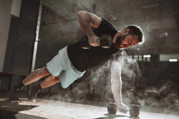 Canvas Print Male During Dumbbell Plank And Pushups