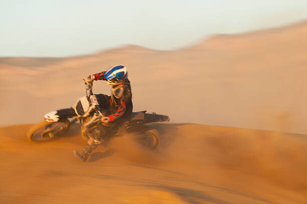 Canvas Print Man motocross riding in desert terrain