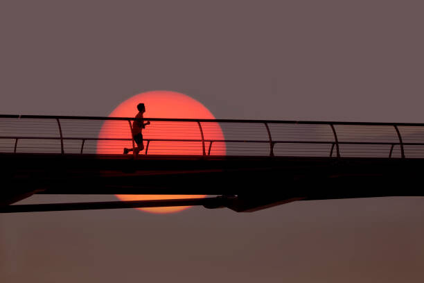 Canvas Print Man out for morning run over bridge.