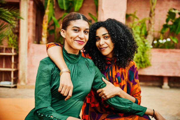 Canvas Print Medium shot of smiling embracing sisters