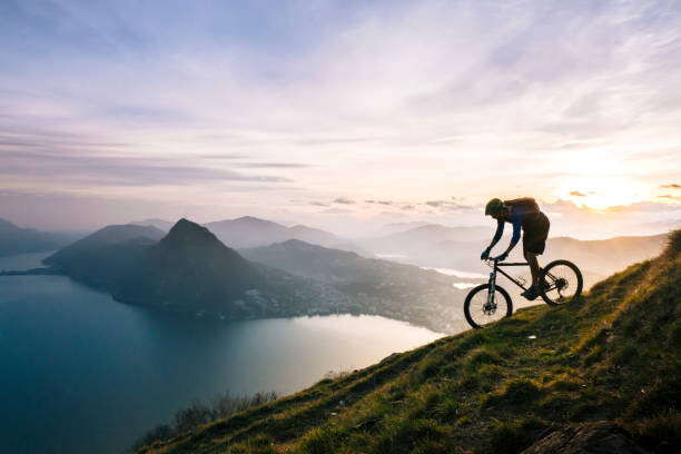 Canvas Print Mountain biker descends steep mountain slope