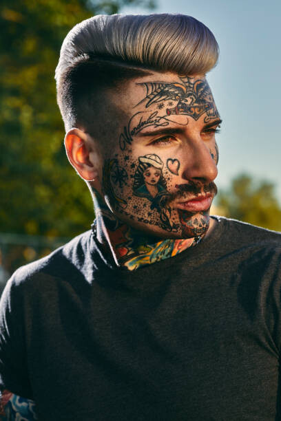 Canvas Print Portrait of tattooed young man outdoors