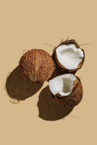 Canvas Print Ripe coconuts on beige background. Creative