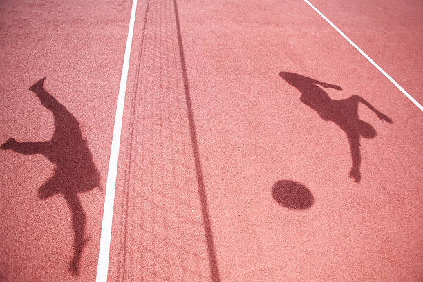 Canvas Print Shadows of athletes playing volleyball