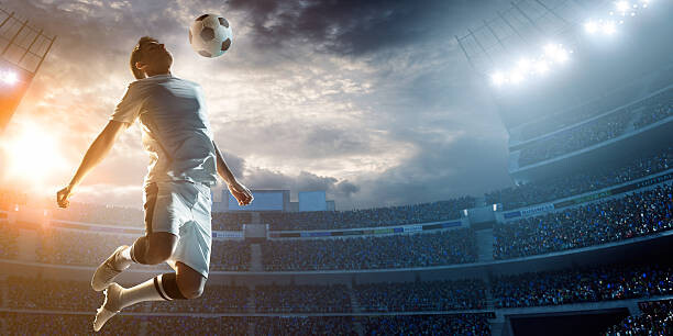 Canvas Print Soccer player kicking ball in stadium